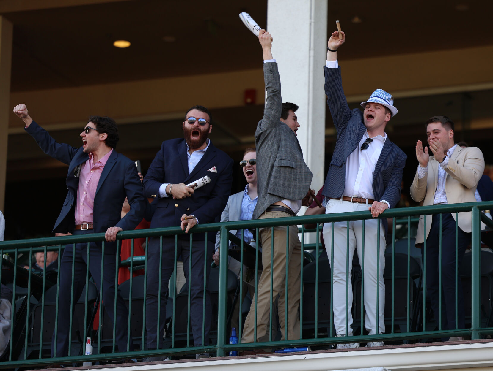 Men celebrate after horse race at Churchill Downs.JPG